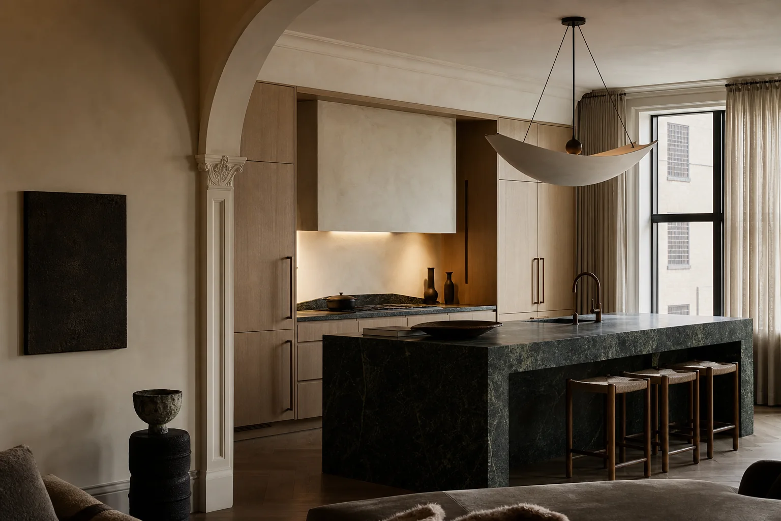 Custom kitchen with a deep green stone island and oak cabinetry.