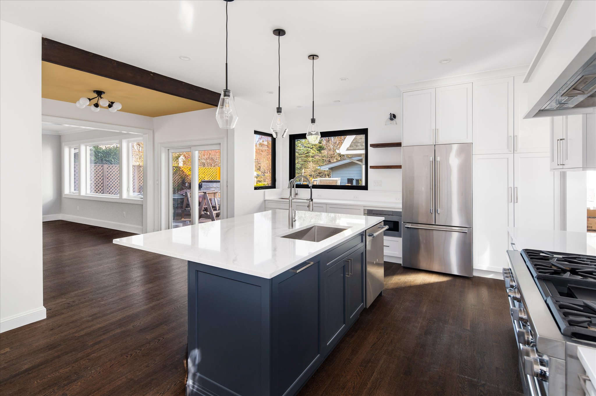 Bright Westchester kitchen with white cabinetry and a deep blue island.